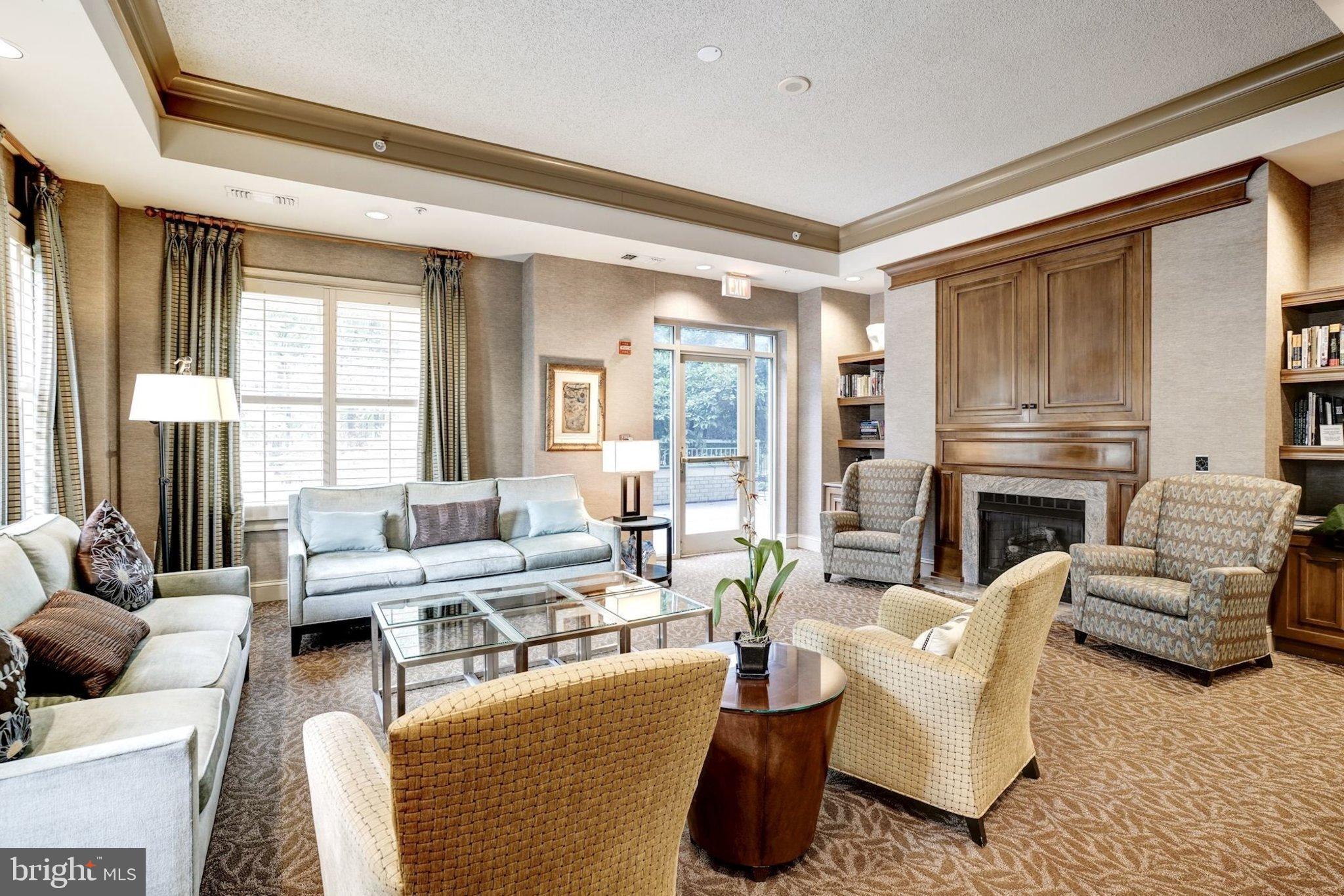 11776 Stratford House Place, Unit 807 Reston, VA 20190 - Photo 23 of 25 a living room with furniture fireplace and a large window