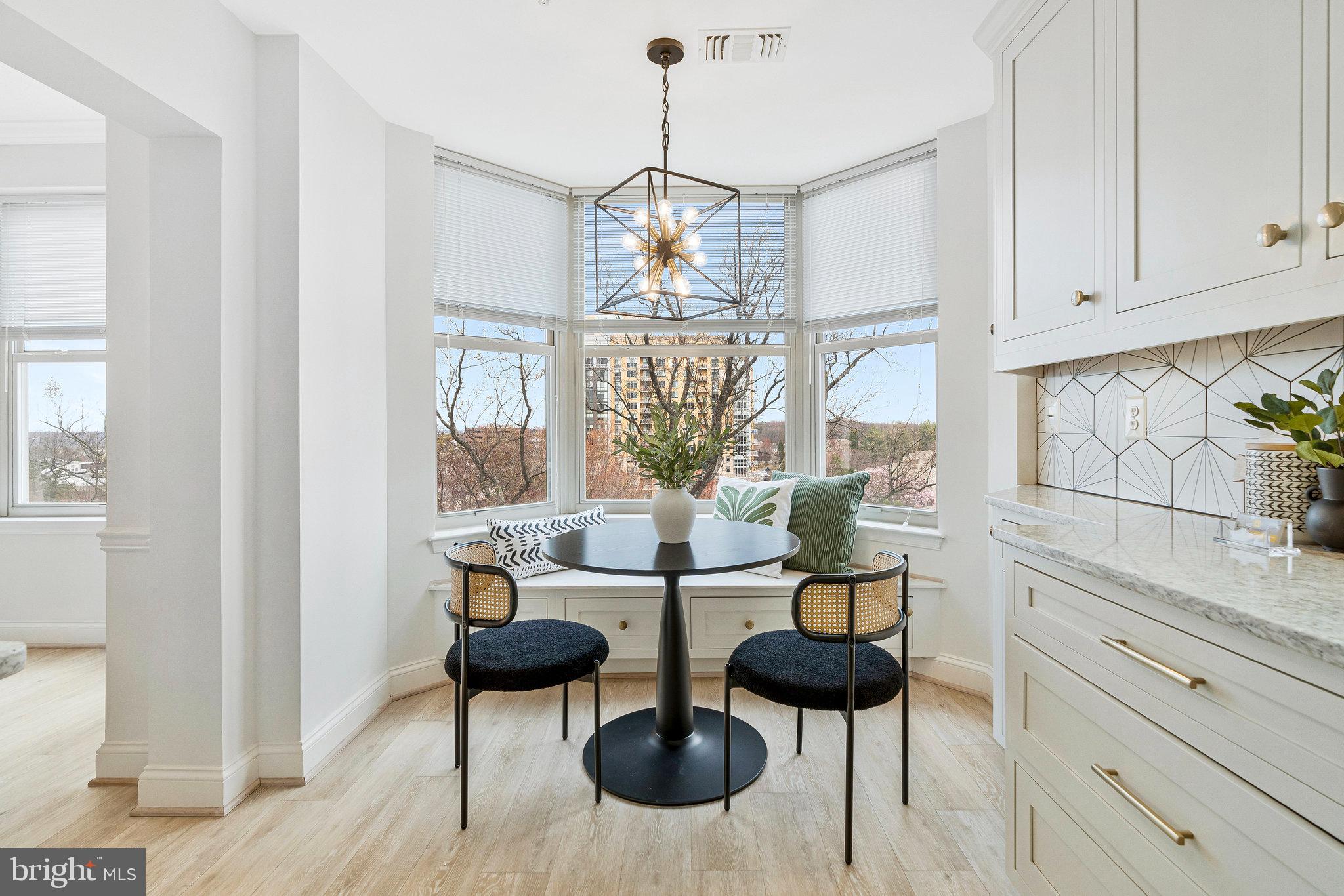 11776 Stratford House Place, Unit 807 Reston, VA 20190 - Photo 6 of 25 a kitchen with stainless steel appliances kitchen island granite countertop a table and chairs in it