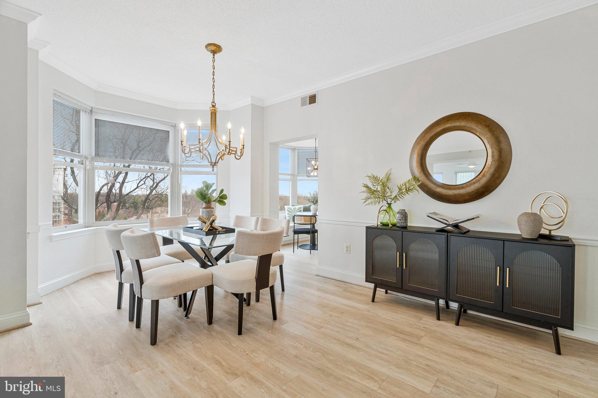11776 Stratford House Place, Unit 807 Reston, VA 20190 - Photo 7 of 25 a dining room with wooden floor a glass table and chairs