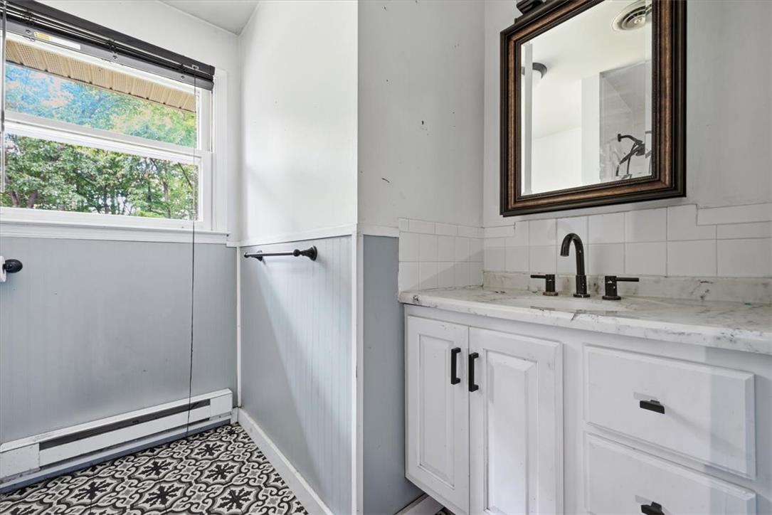 9870 North Delaware Drive Bangor, PA 18013 - Photo 30 of 62 Patterned tile flooring and a stone-topped vanity define this bathroom space.