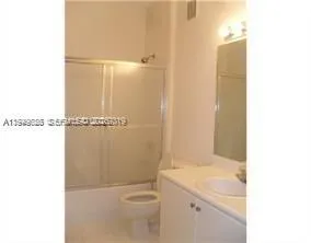 a bathroom with a sink a toilet and a shower