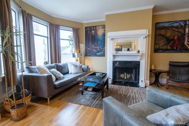 a living room with furniture and a fireplace