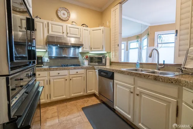 a kitchen with a sink stove and cabinets