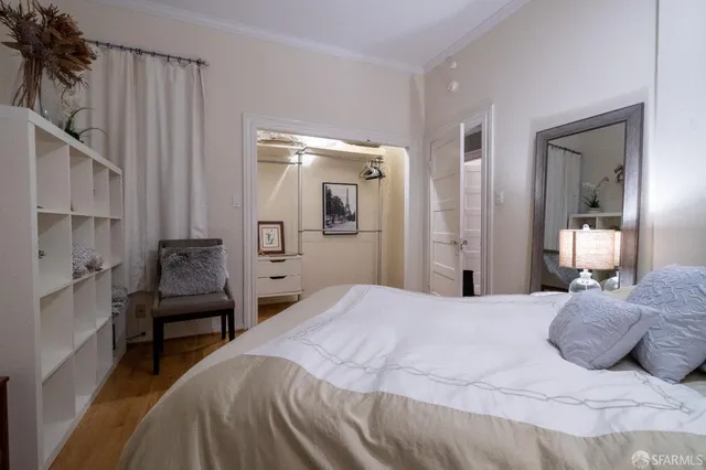 a bedroom with a bed and a large mirror