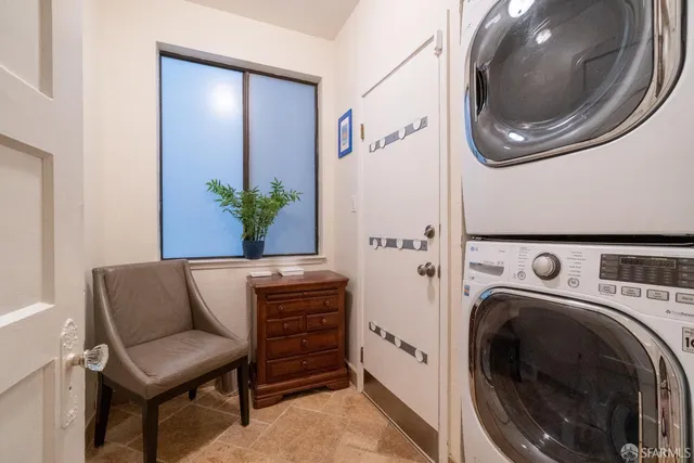 a living room with furniture and a washer dryer