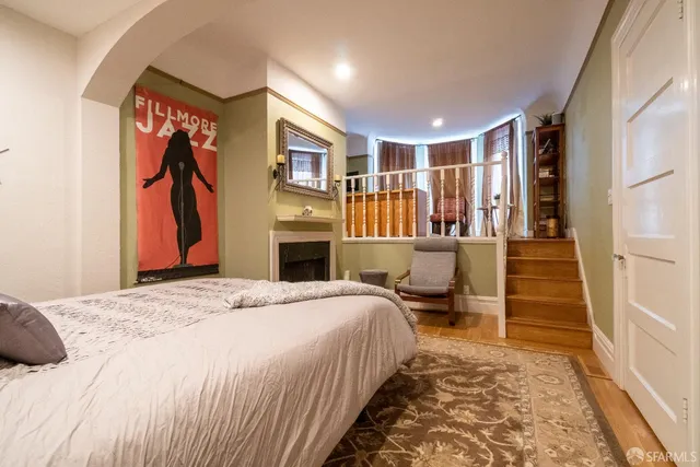 a bedroom with a large bed and a chandelier