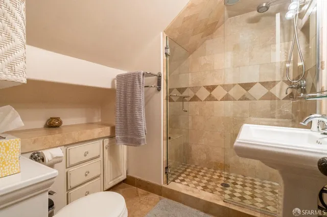 a bathroom with a sink toilet and shower