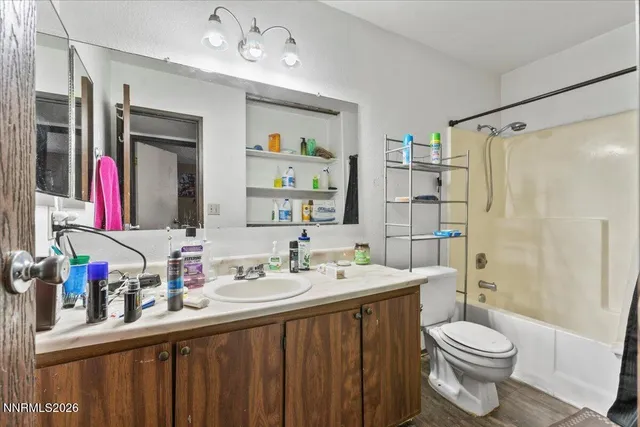 a bathroom with a sink vanity mirror and toilet