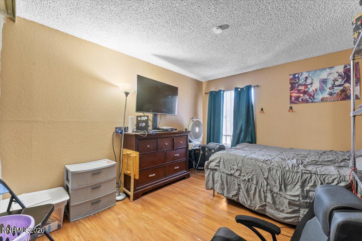 4608 Neil Road, Unit 269 Reno, NV 89502 - Photo 14 of 20 a bedroom with a bed and furniture