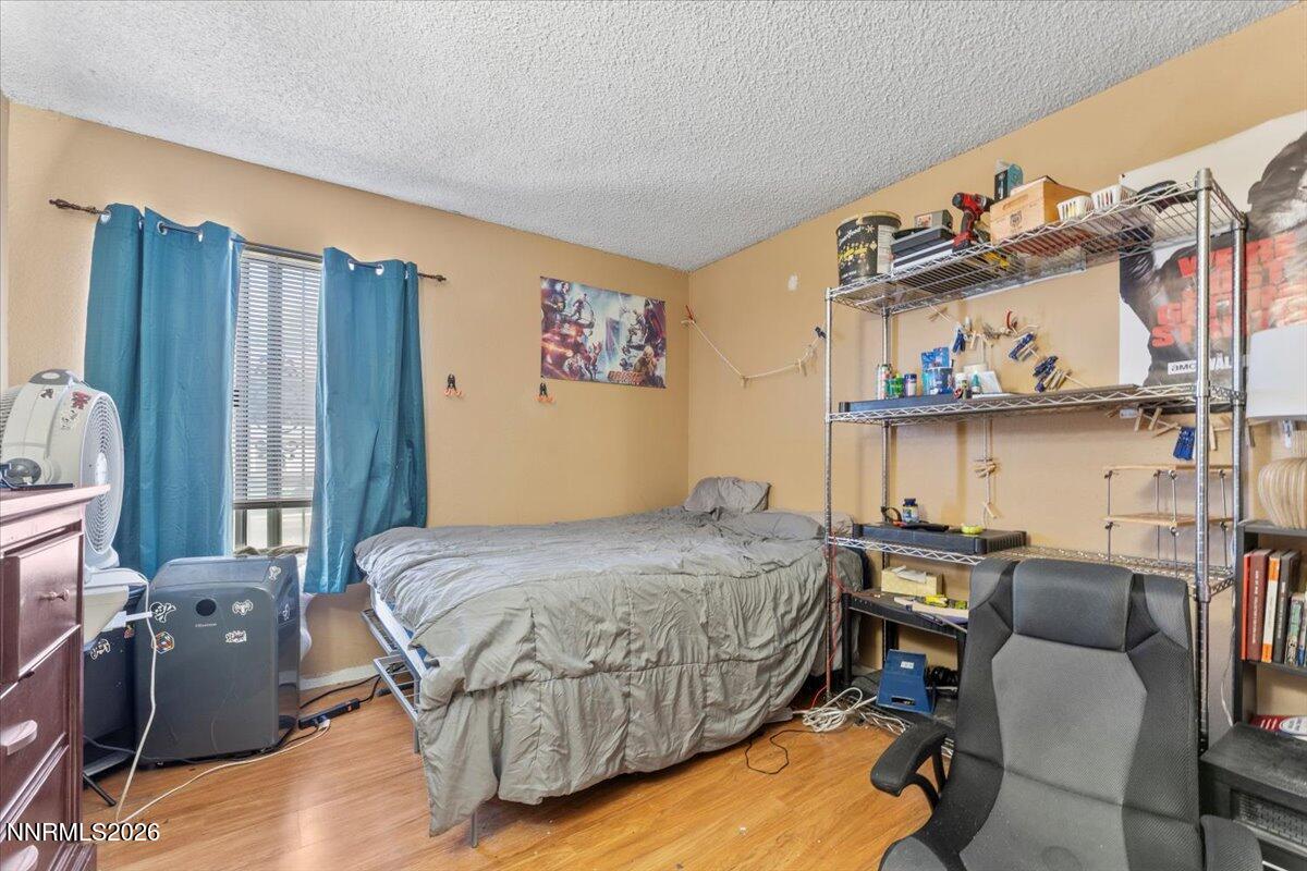 4608 Neil Road, Unit 269 Reno, NV 89502 - Photo 15 of 20 a bedroom with a bed window and chair