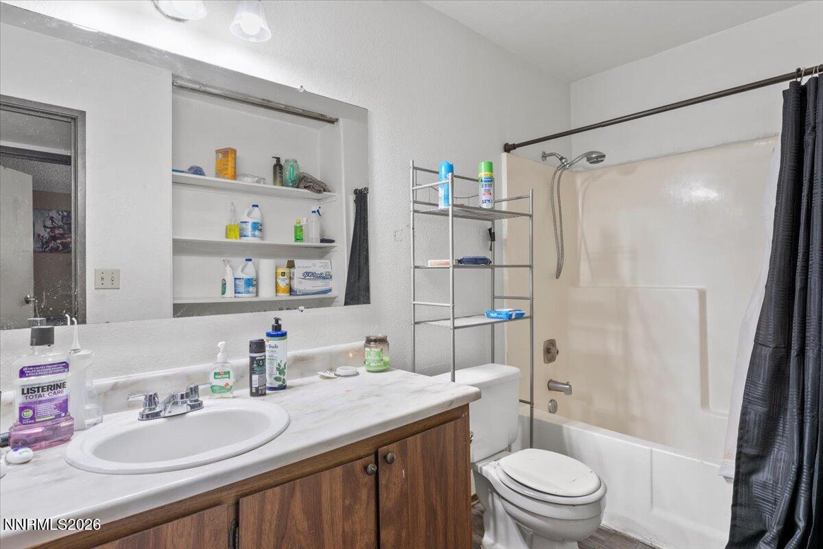 4608 Neil Road, Unit 269 Reno, NV 89502 - Photo 17 of 20 a bathroom with a granite countertop sink toilet and shower
