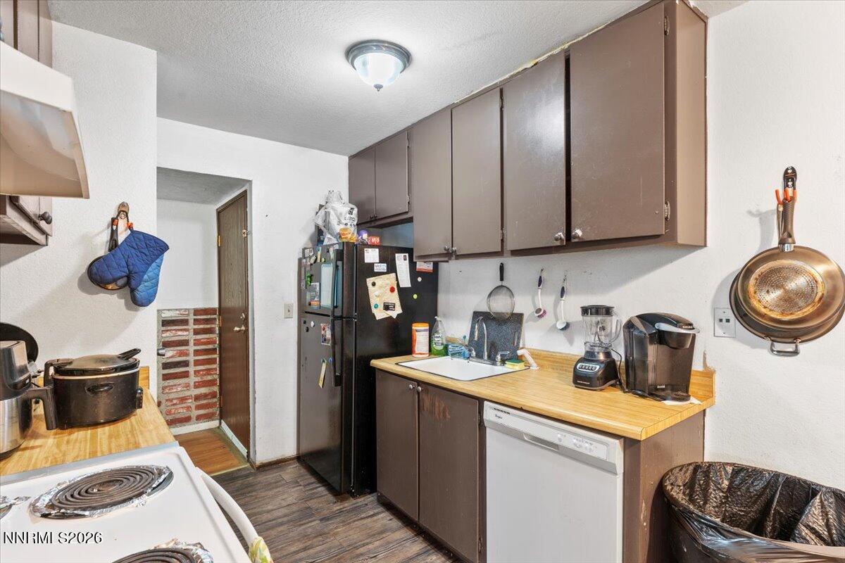 4608 Neil Road, Unit 269 Reno, NV 89502 - Photo 9 of 20 a kitchen with a refrigerator and a stove top oven