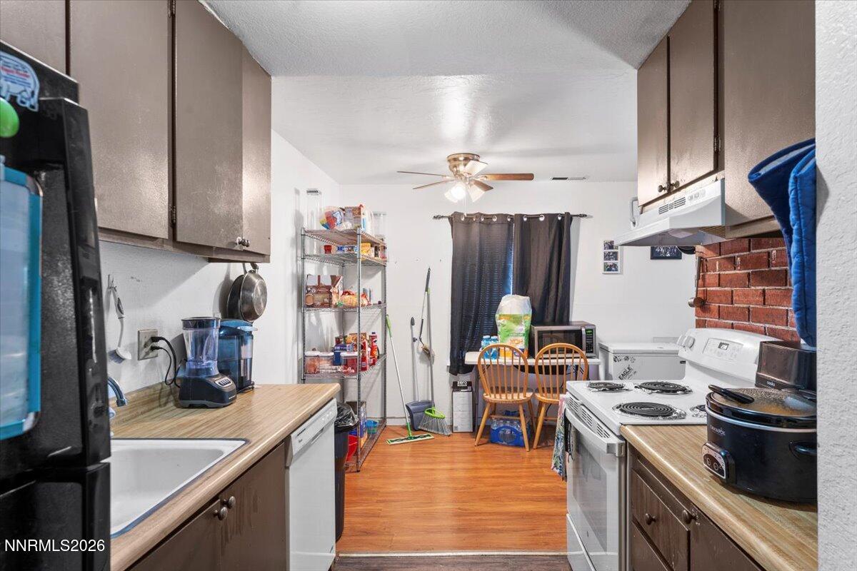 4608 Neil Road, Unit 269 Reno, NV 89502 - Photo 10 of 20 a kitchen with stainless steel appliances kitchen island granite countertop a stove and a sink