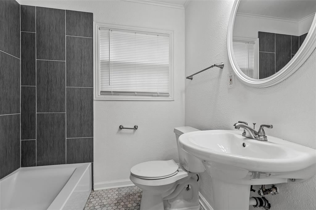 3104 Fadal Avenue Waco, TX 76708 - Photo 13 of 17 a bathroom with a sink a toilet and shower