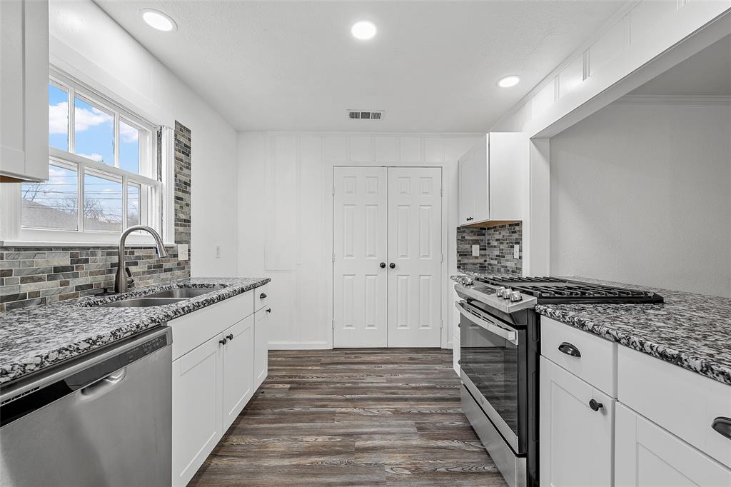 3104 Fadal Avenue Waco, TX 76708 - Photo 4 of 17 a kitchen with stainless steel appliances granite countertop a stove and a sink