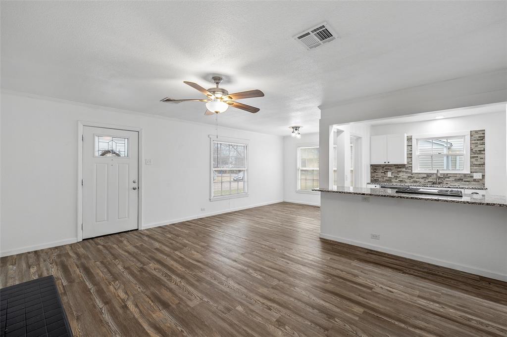 3104 Fadal Avenue Waco, TX 76708 - Photo 7 of 17 an empty room with wooden floor and windows