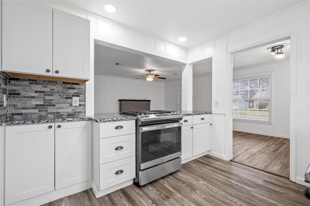 3104 Fadal Avenue Waco, TX 76708 - Photo 8 of 17 a kitchen with stainless steel appliances white cabinets and a wooden floor