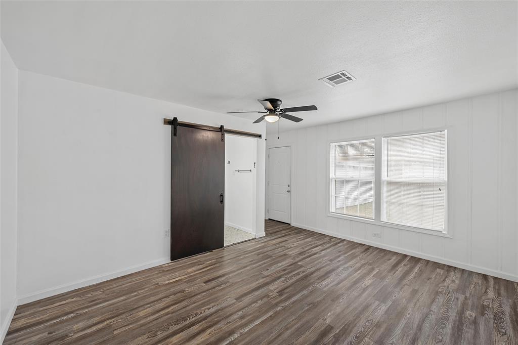 3104 Fadal Avenue Waco, TX 76708 - Photo 9 of 17 a view of an empty room with wooden floor and a window