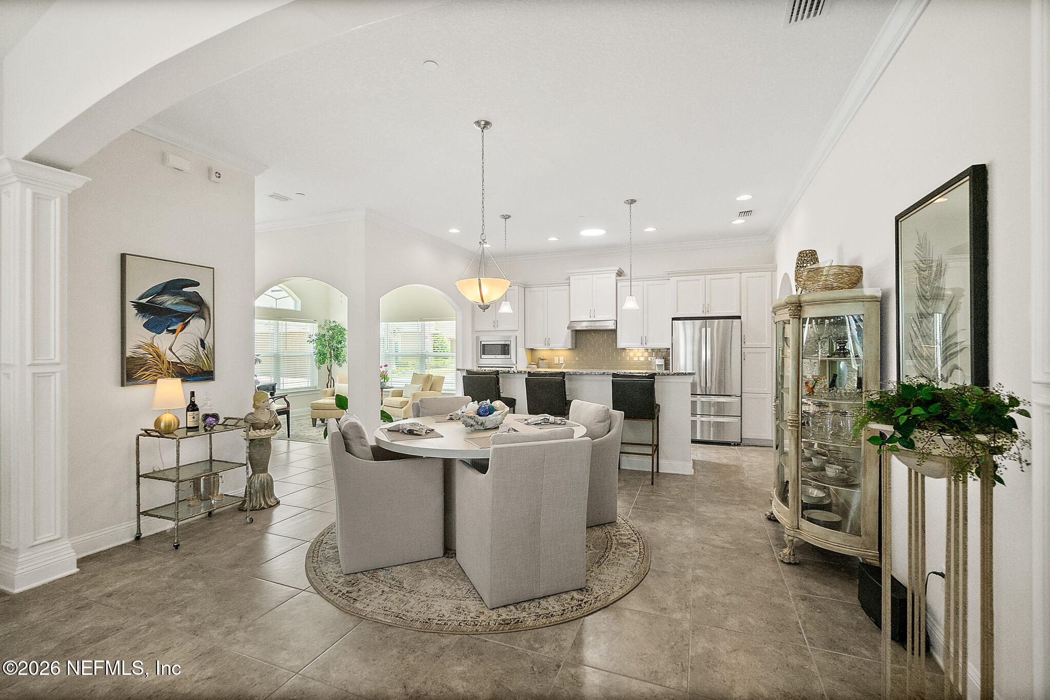 44 Utina Way St. Augustine, FL 32084 - Photo 14 of 48 a living room with stainless steel appliances kitchen island granite countertop a table chairs and a view of living room