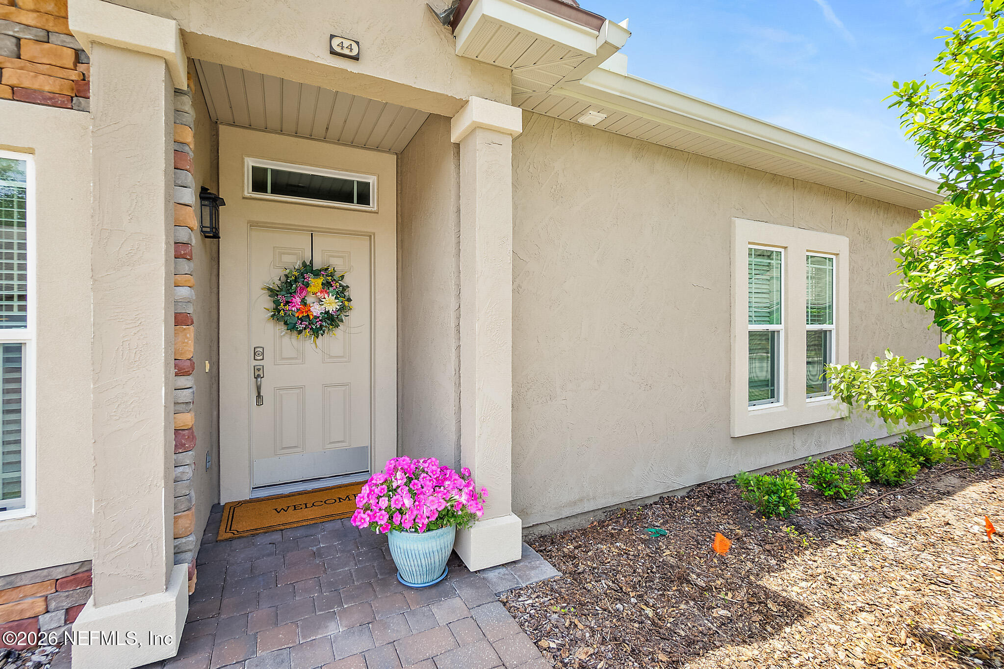 44 Utina Way St. Augustine, FL 32084 - Photo 2 of 48 a pink flowers in front of a door