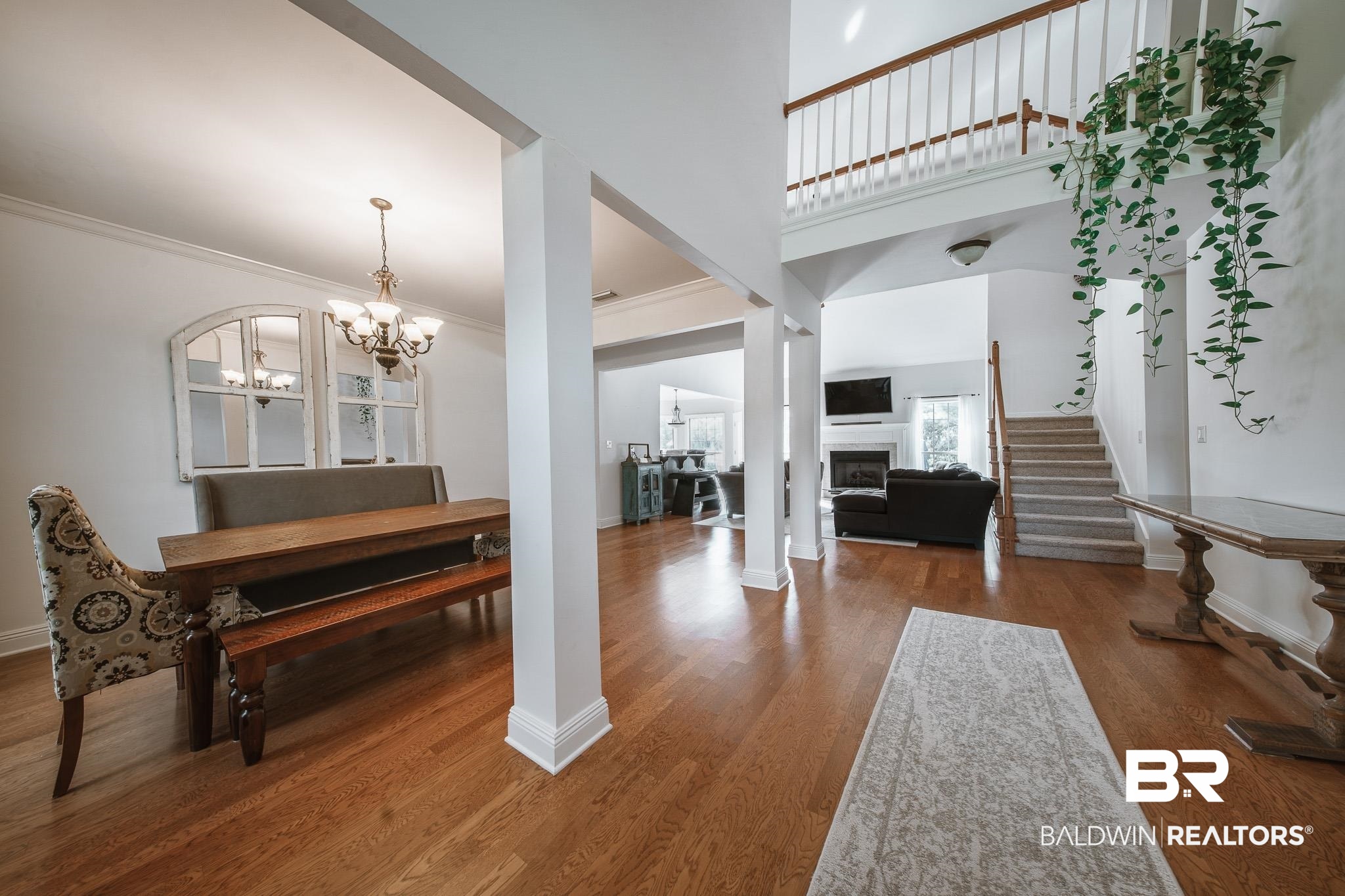 8421 Weatherford Court Daphne, AL 36527 - Photo 5 of 36 Foyer entrance with a chandelier, crown molding, stairs, a fireplace, and wood finished floors