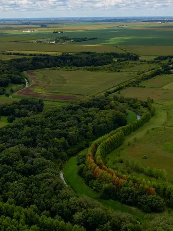 a view of a field with an ocean view