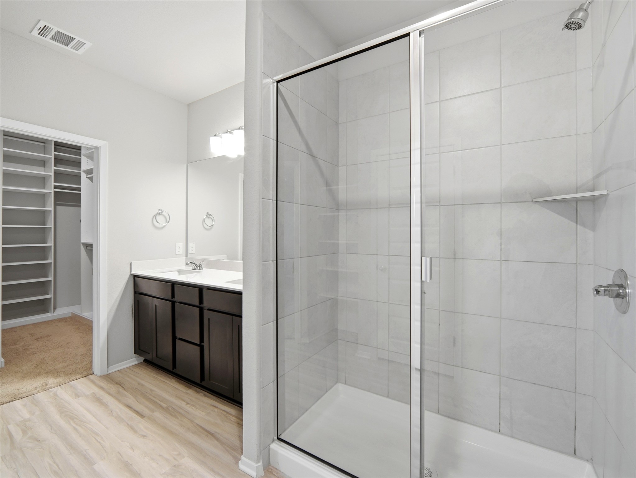 60 Bent Trl Lane Georgetown, TX 78628 - Photo 28 of 40 A well-appointed primary bath features a spacious glass-enclosed shower and dual-sink vanity with abundant storage.