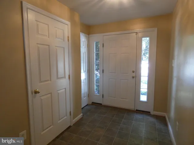an empty room with closet and a bathroom