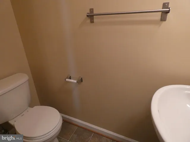 a white toilet sitting next to a shower