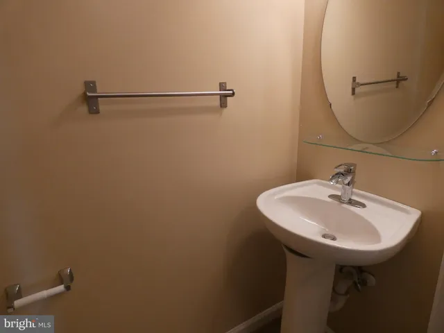 a bathroom with a sink a mirror and a toilet