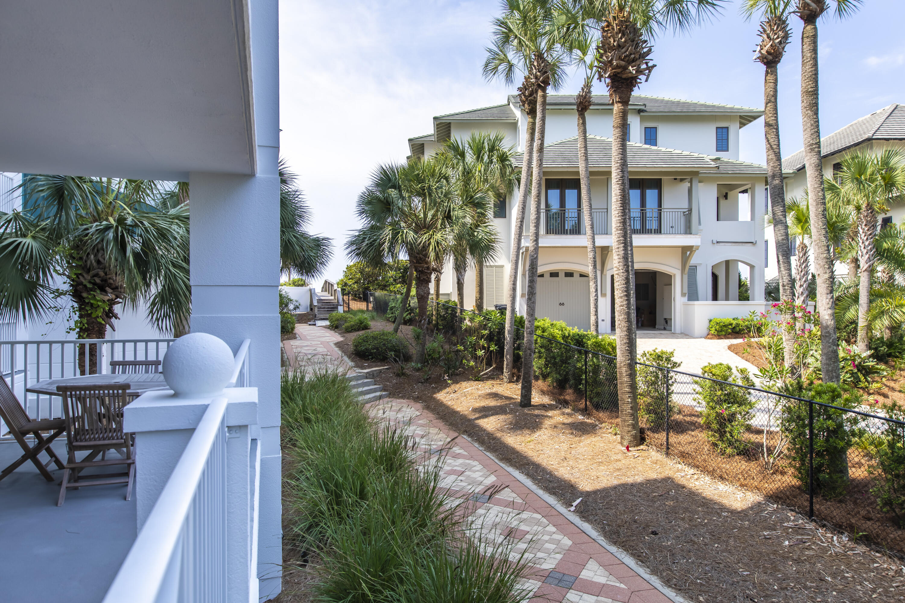 164 Blue Lupine Way, Unit 121 Santa Rosa Beach, FL 32459 - Photo 8 of 9 a view of a patio with table and chairs and potted plants