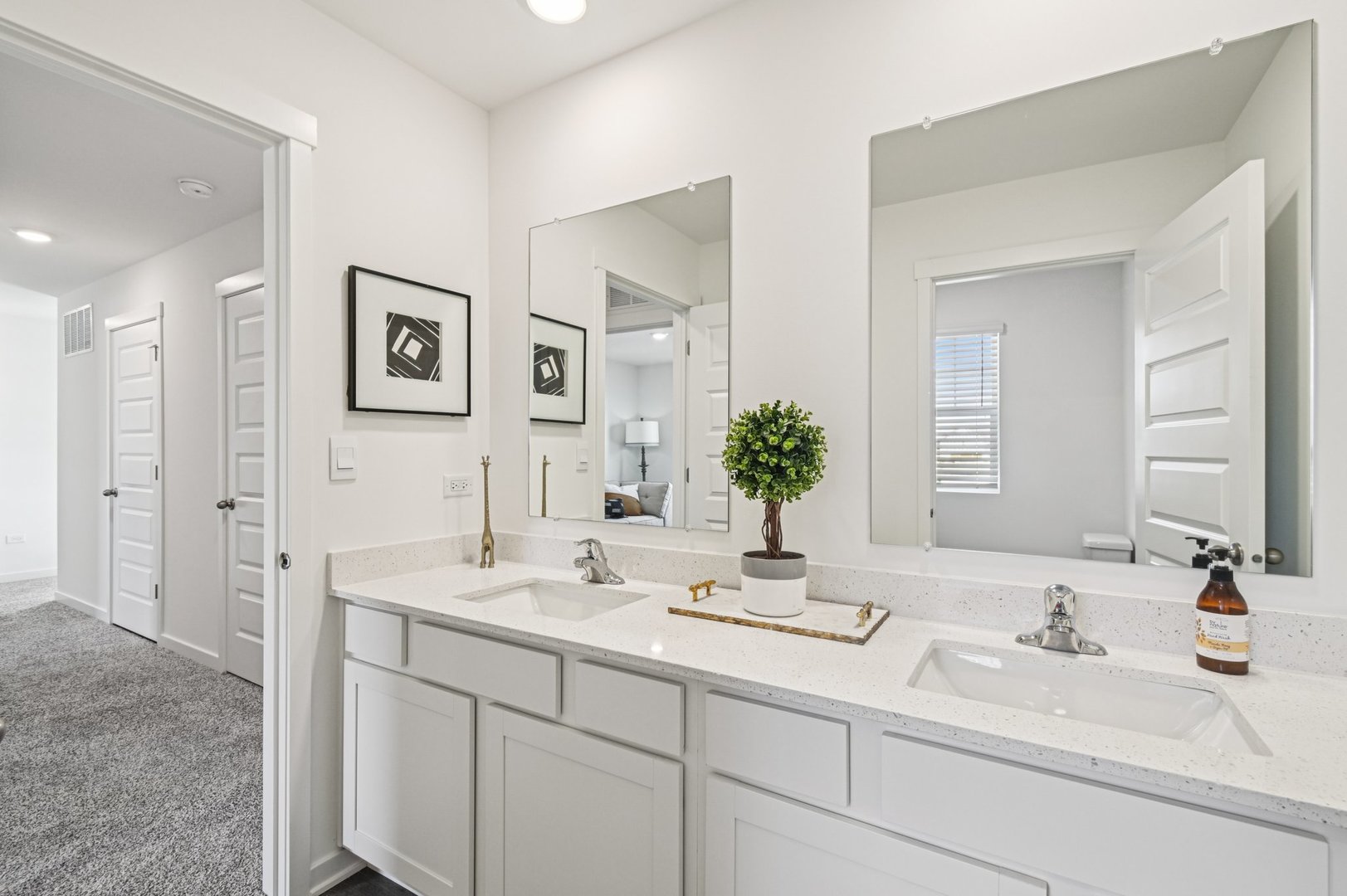 2497 Semillon Street Oswego, IL 60543 - Photo 34 of 37 a bathroom with double vanity sinks and a mirror