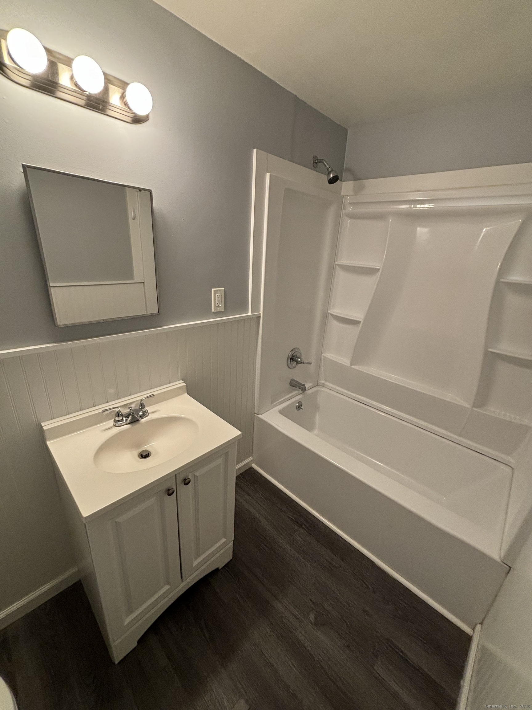 76 Birdsey Street, Unit 1R Bridgeport, CT 06610 - Photo 3 of 8 a bathroom with a sink a mirror and a bathtub