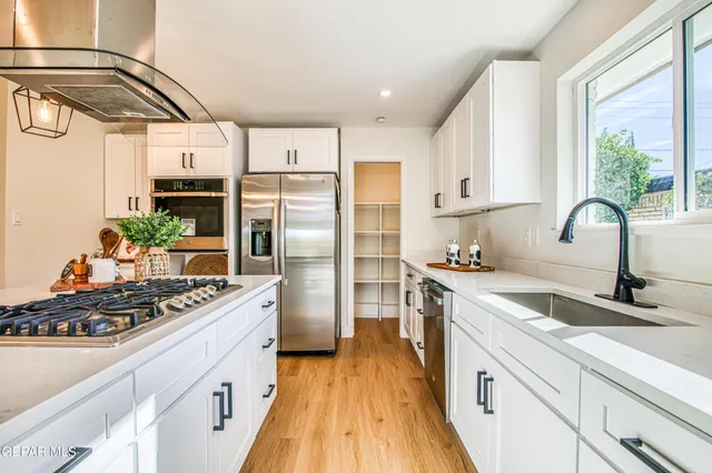 a kitchen with stainless steel appliances a refrigerator and a stove