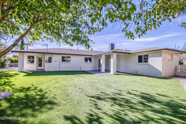 a view of empty room with wooden floor and window