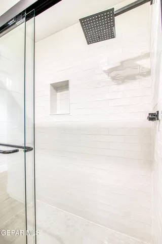 a bathroom with a double vanity sink toilet and shower