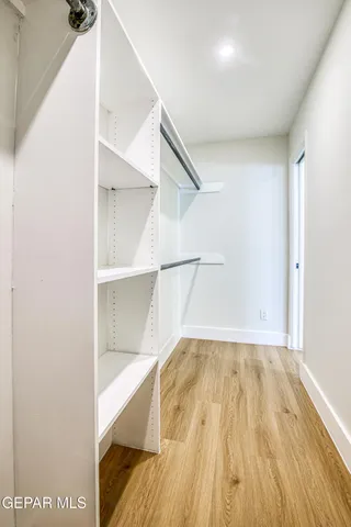 a view of a white house with a yard table and chairs