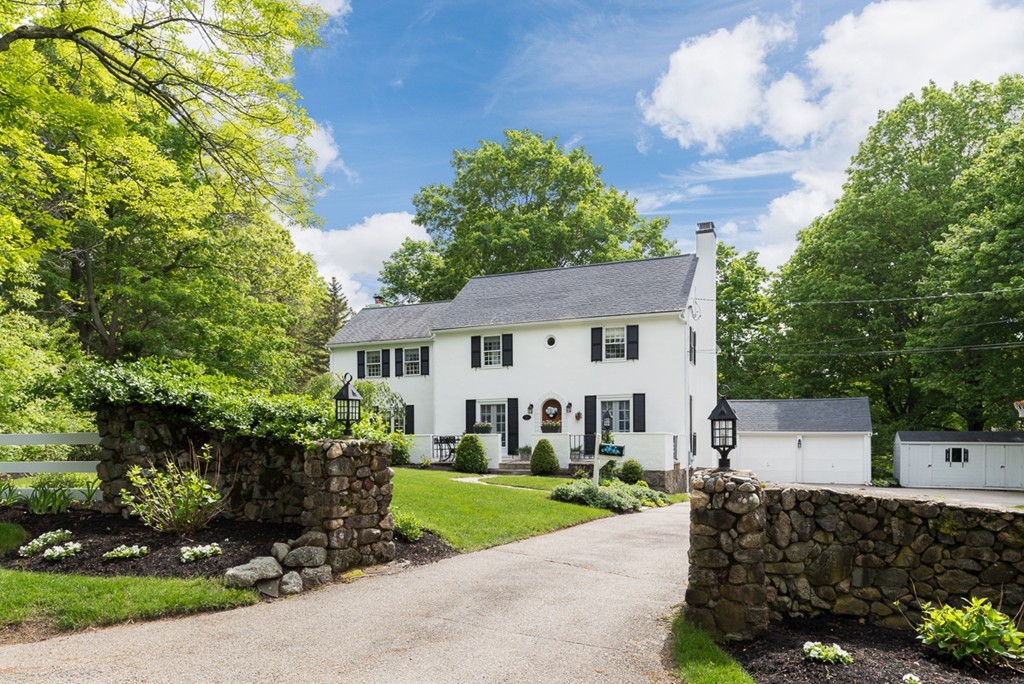 a front view of a house with a garden