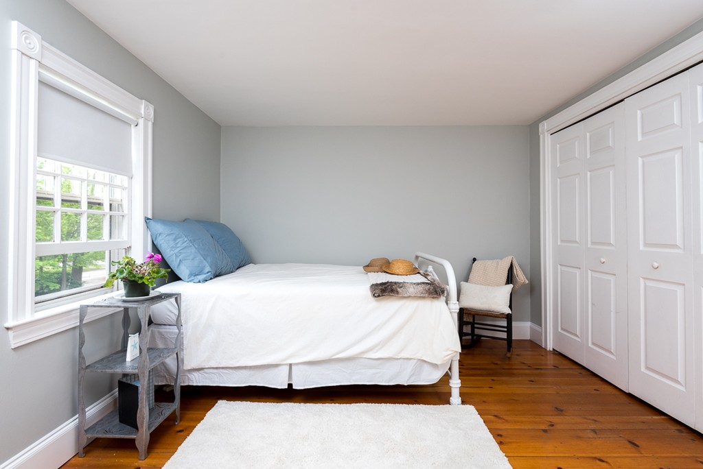 68 Cross Street Hingham, MA 02043 - Photo 15 of 26 a bedroom with a bed and wooden floor