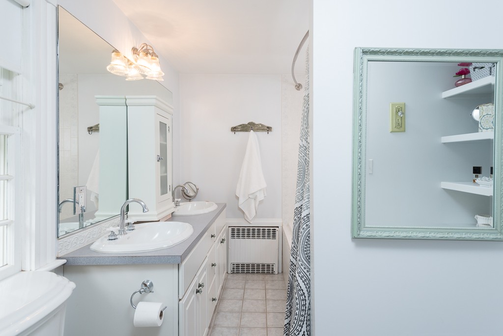 68 Cross Street Hingham, MA 02043 - Photo 19 of 26 a bathroom with a sink a mirror and a toilet