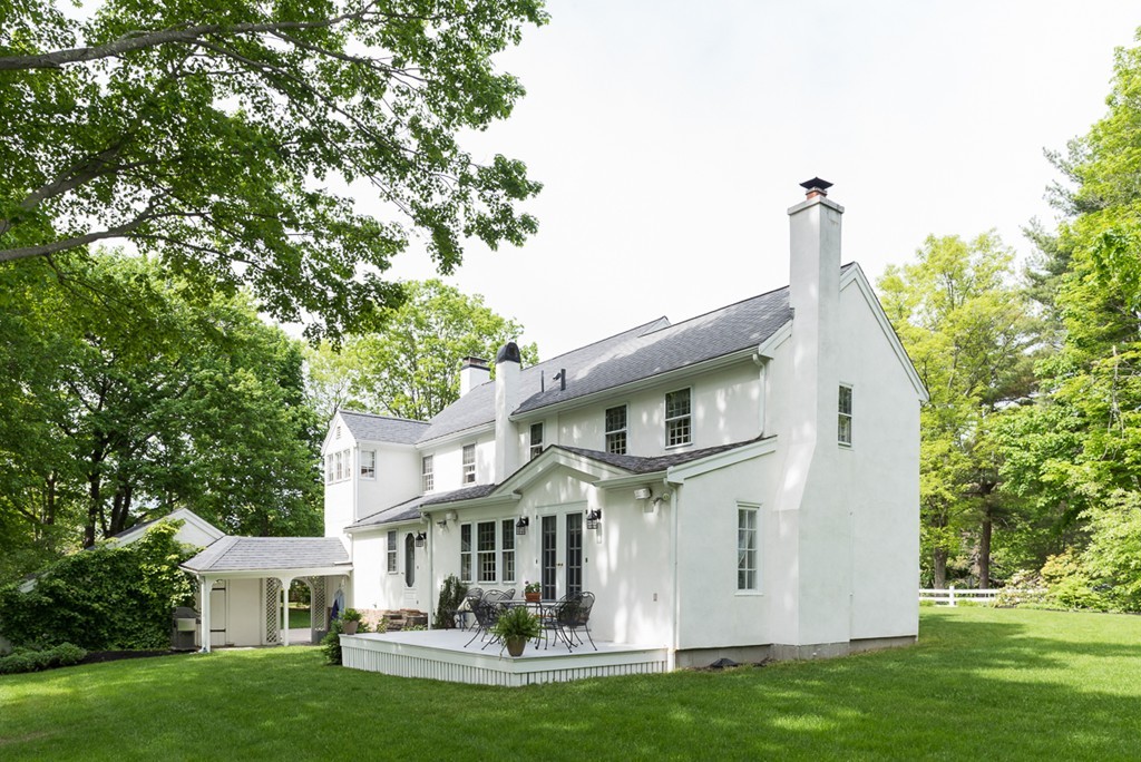 68 Cross Street Hingham, MA 02043 - Photo 22 of 26 a front view of a house with a garden and plants