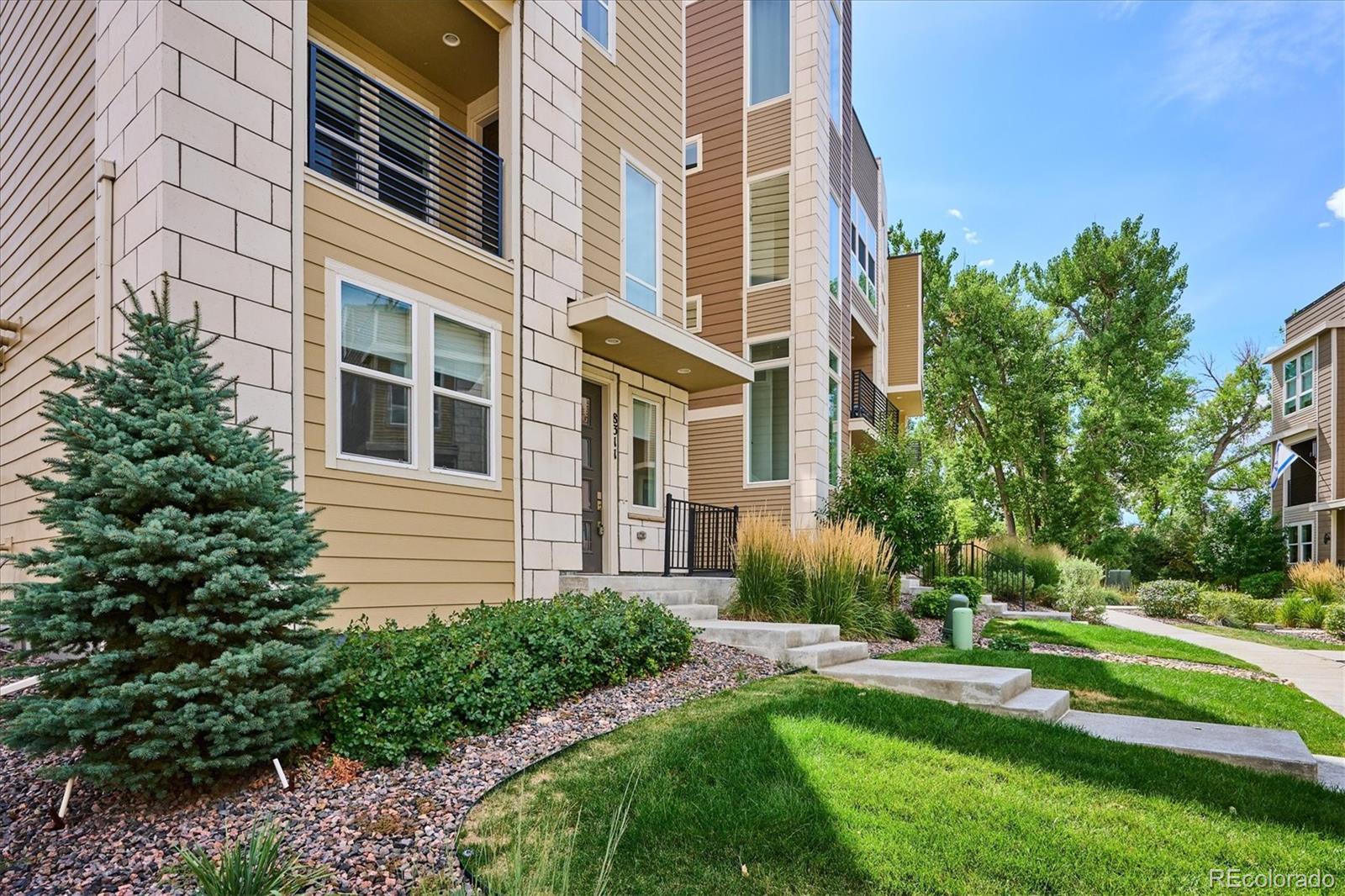8311 Riverscape Court Highlands Ranch, CO 80129 - Photo 3 of 50 a view of a building next to a yard