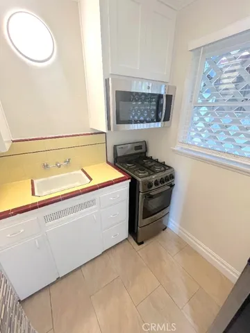a bathroom with a granite countertop sink and a bathtub
