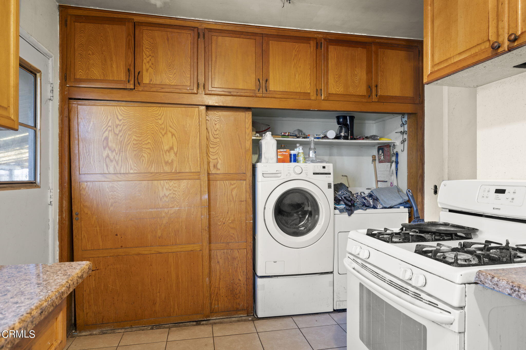 4829 Saviers Road Oxnard, CA 93033 - Photo 18 of 31 a kitchen with a refrigerator and a stove top oven