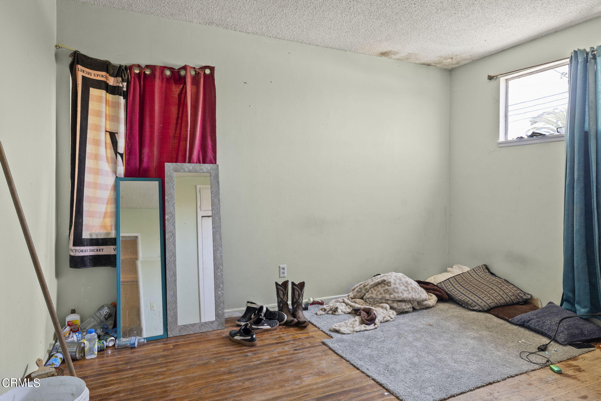 4829 Saviers Road Oxnard, CA 93033 - Photo 24 of 31 a bedroom with a bed and wooden floor