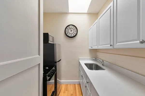 a kitchen with a refrigerator and a stove