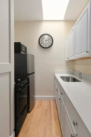 a kitchen with a refrigerator and a sink
