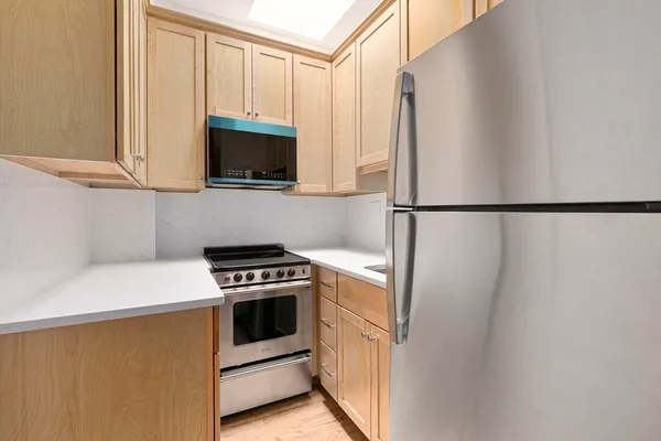 a kitchen with a refrigerator stove and microwave