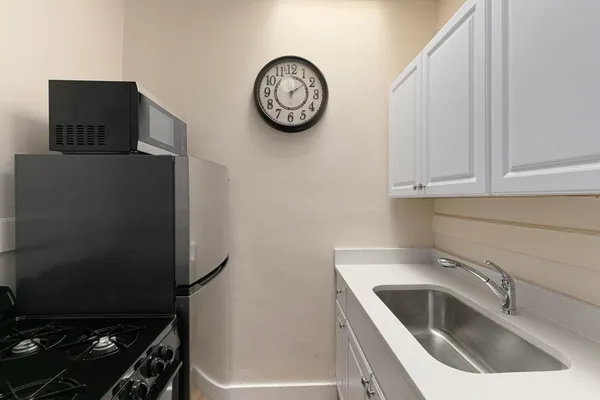 a kitchen with a refrigerator and a sink