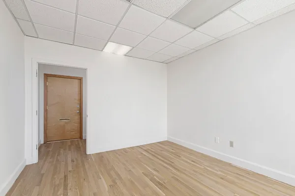 a view of a room with wooden floor